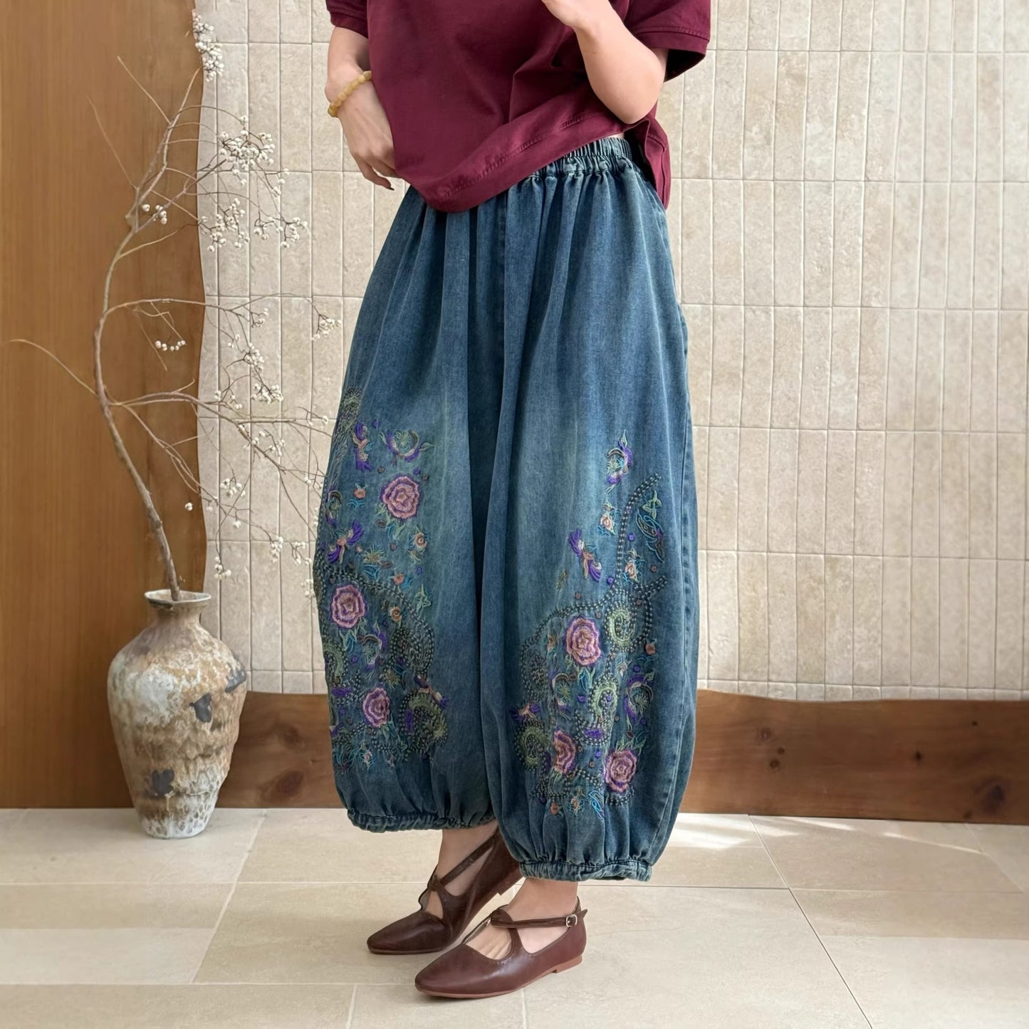 Close-up of embroidered floral pants with soft decorative pattern