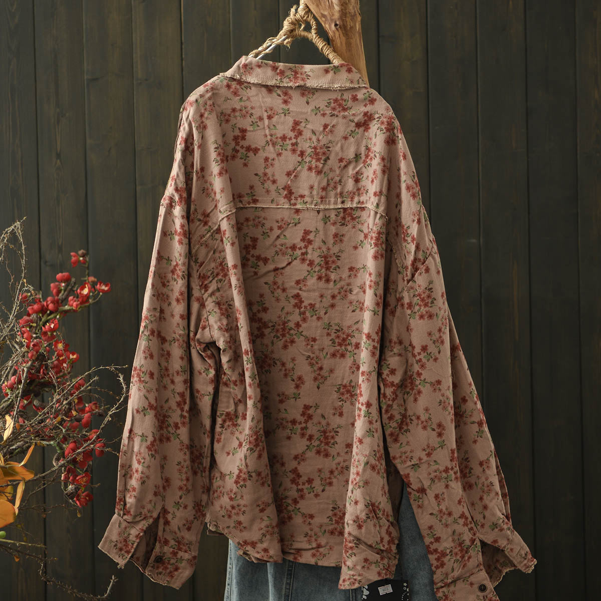 Back view of the lightweight unlined distressed floral shirt, emphasizing its relaxed fit and vintage charm.