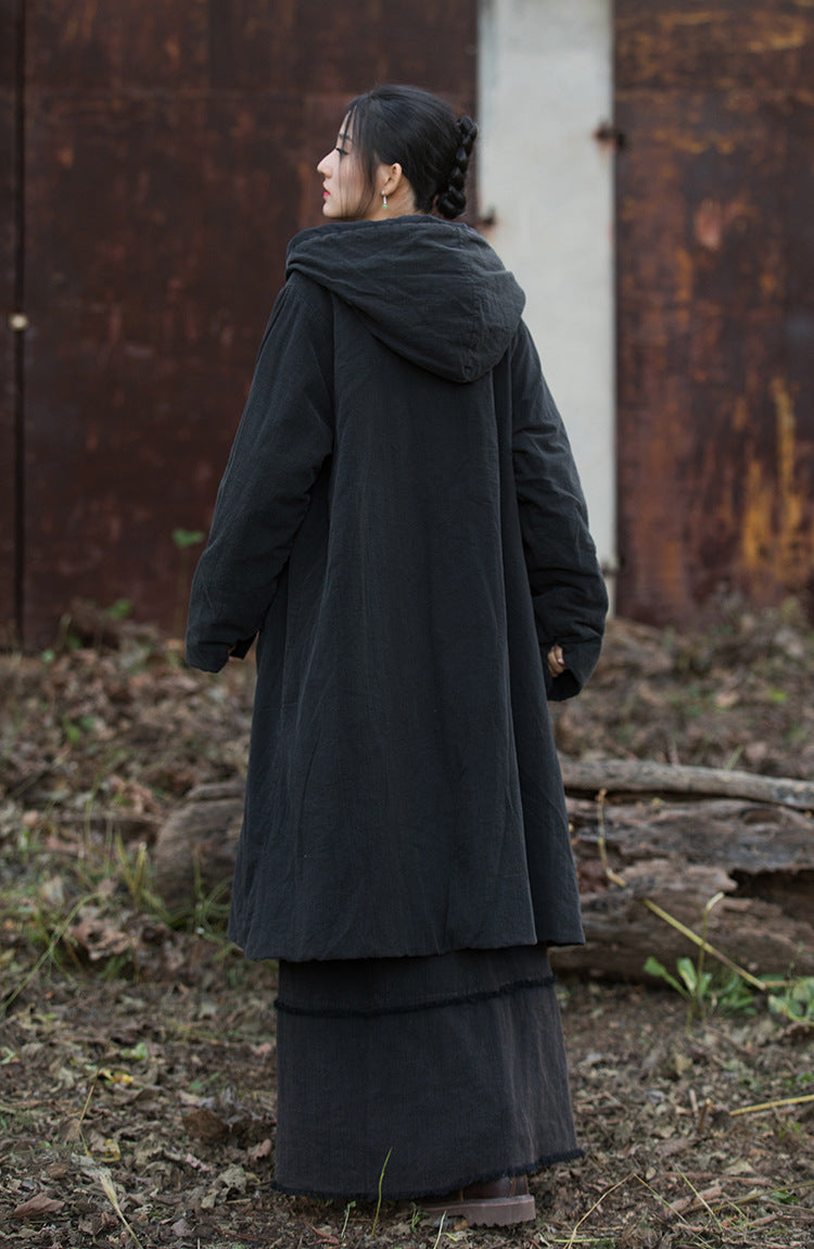 Front tie closure detail on black quilted coat