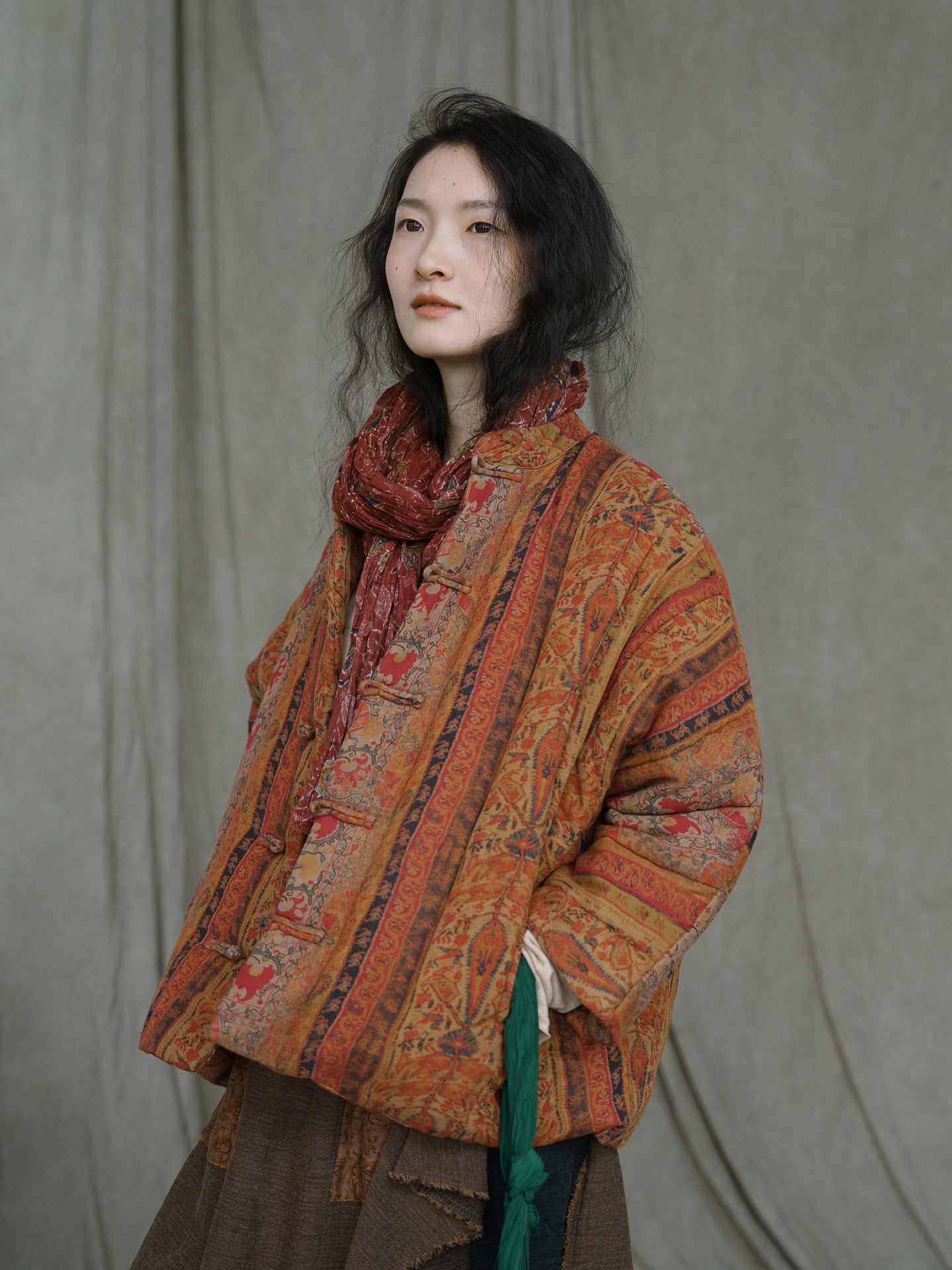 Model wearing amber floral patchwork winter down coat outdoors