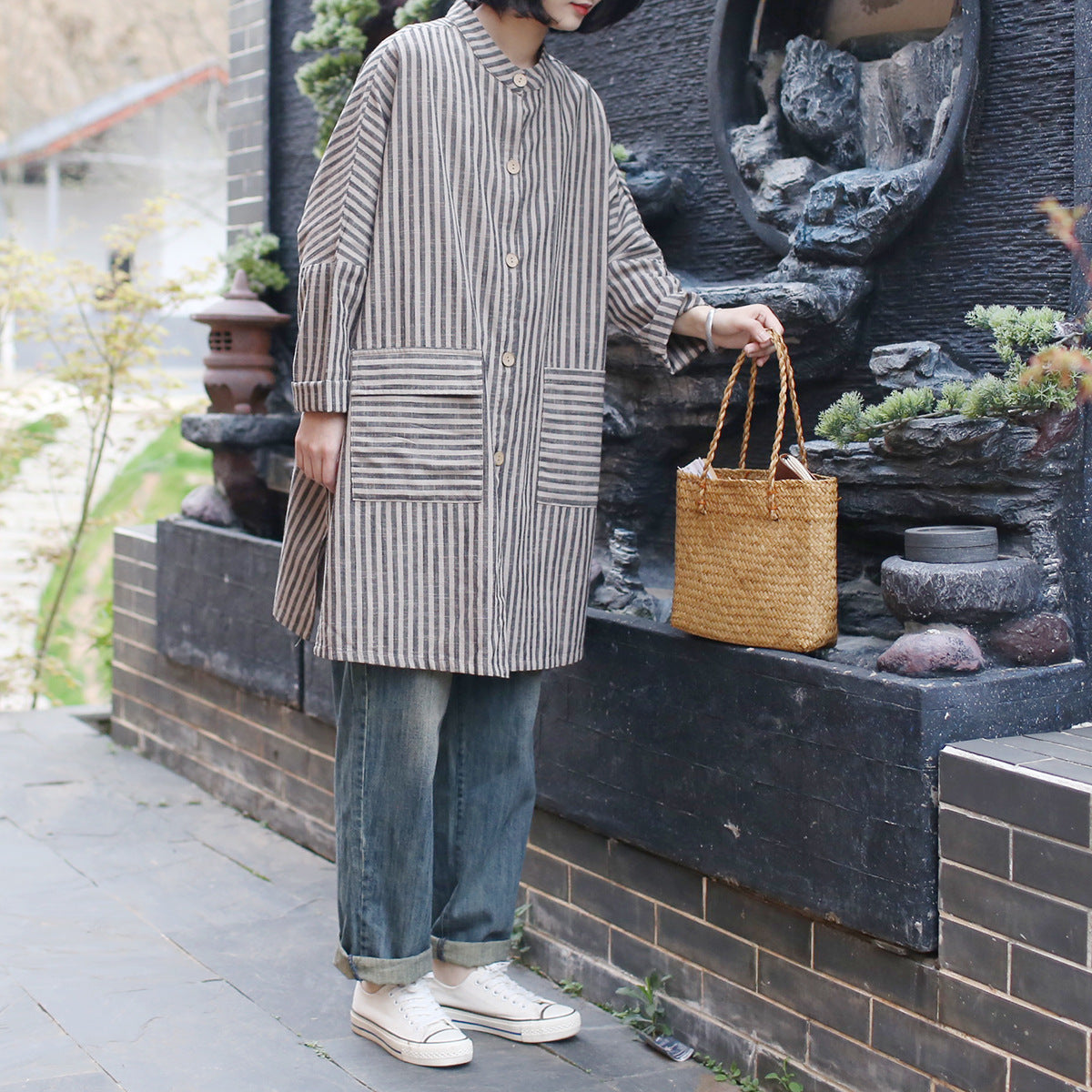 Side profile of a loose-fit striped cotton linen blouse