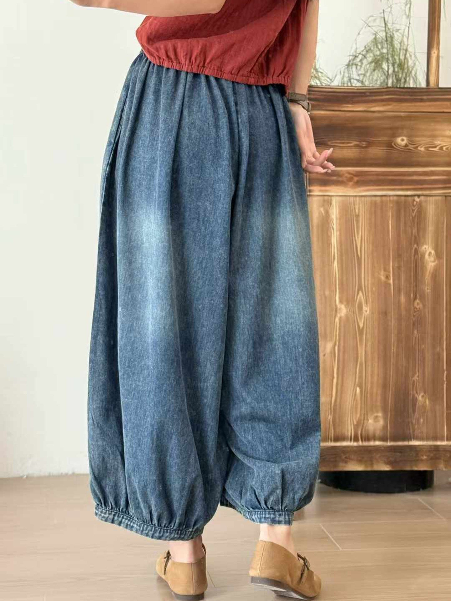 Back view of embroidered denim pants with an easy relaxed silhouette