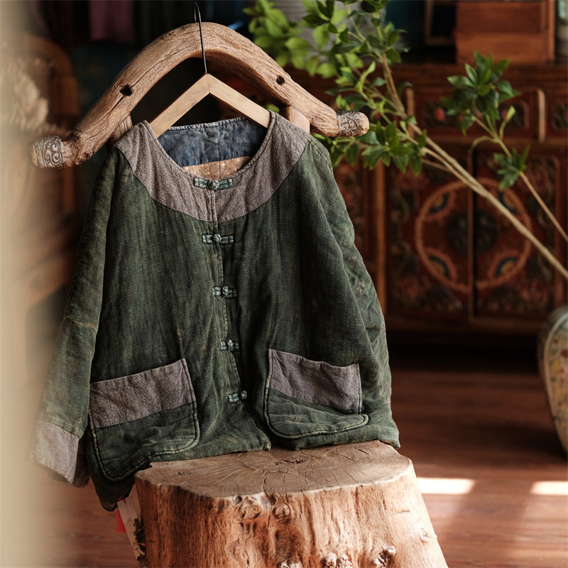 Close-up detail of distressed quilted green coat padded stitching