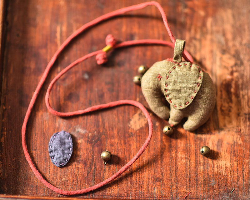 Handcrafted linen elephant accessory displayed as a whimsical accent