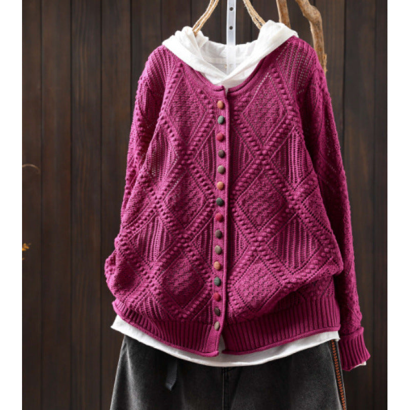 Open-knit sweater with colorful button details close-up