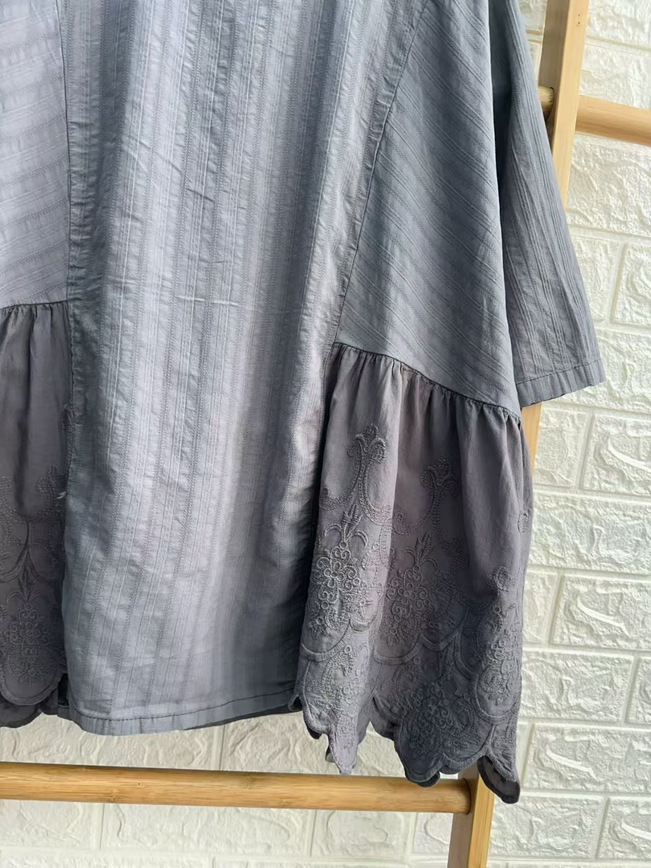 Close-up embroidery detail on patchwork cotton blouse