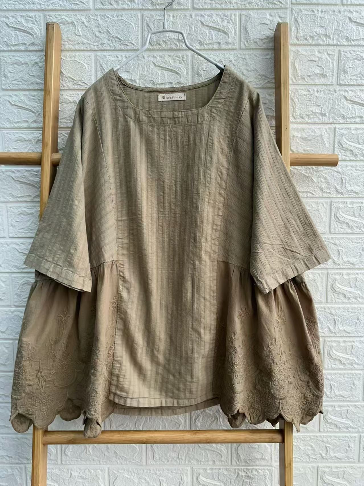 Woman wearing patchwork embroidered cotton blouse styled casually