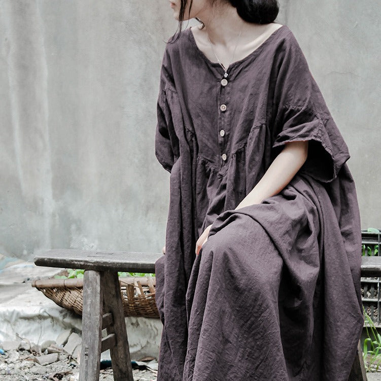 Model wearing a relaxed linen dress in natural sunlight