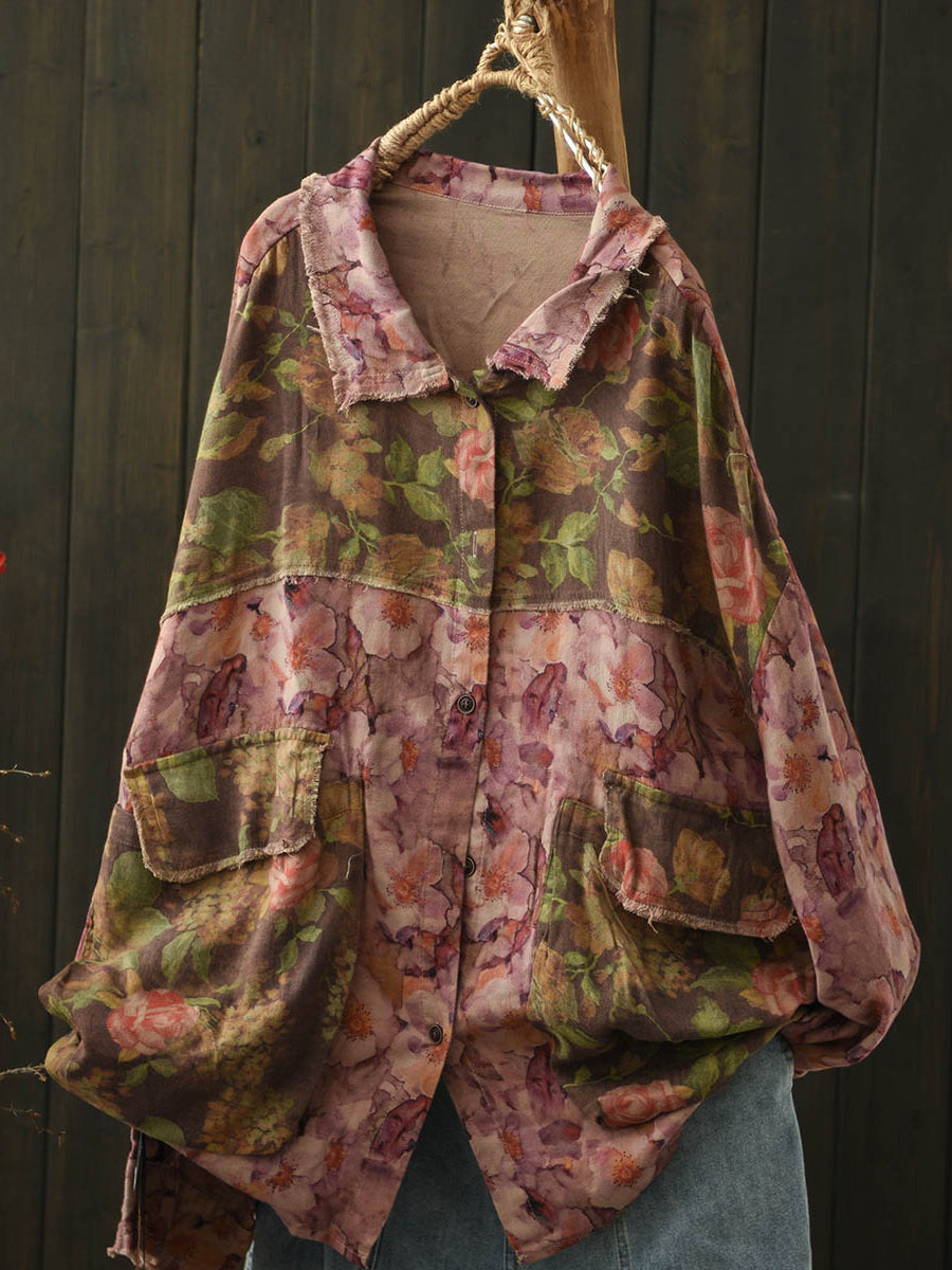 highlighting the asymmetric hem of the lightweight unlined distressed floral blouse, showcasing its elegant vintage design.