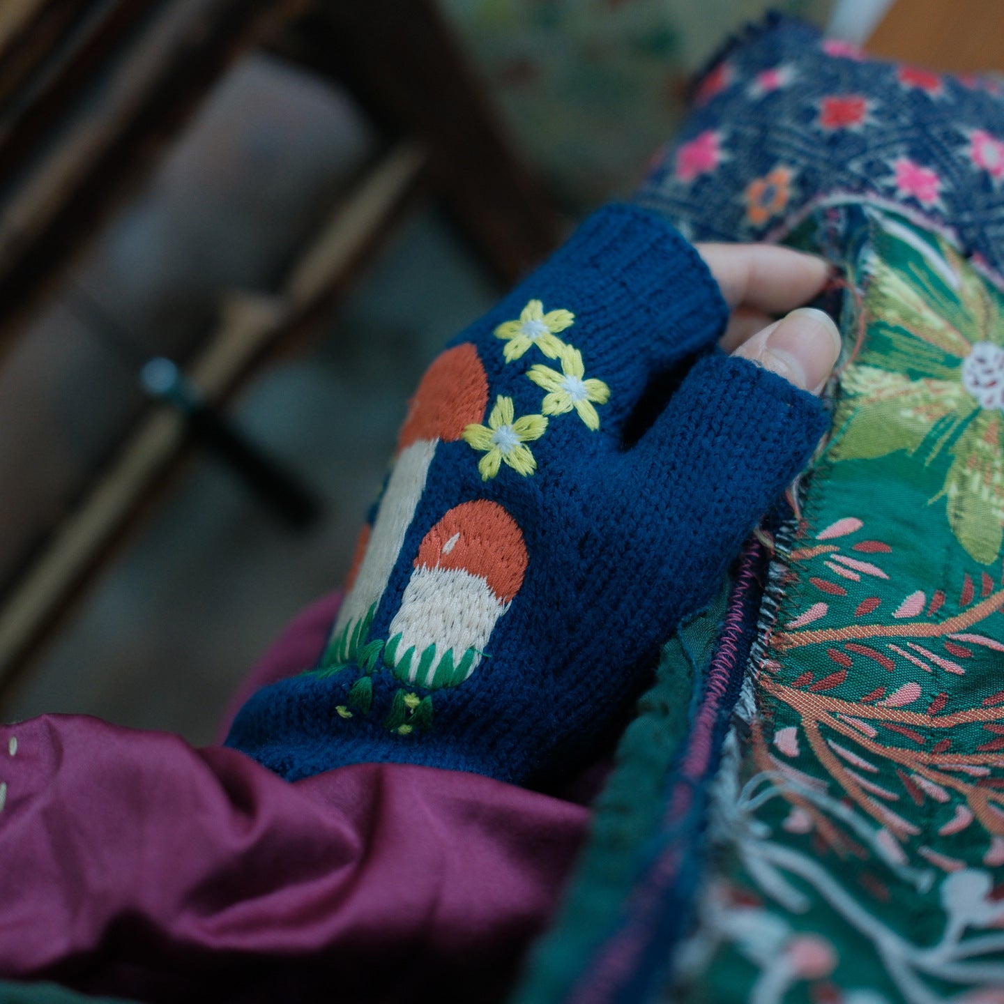 Detail view of embroidery on vintage knitted gloves